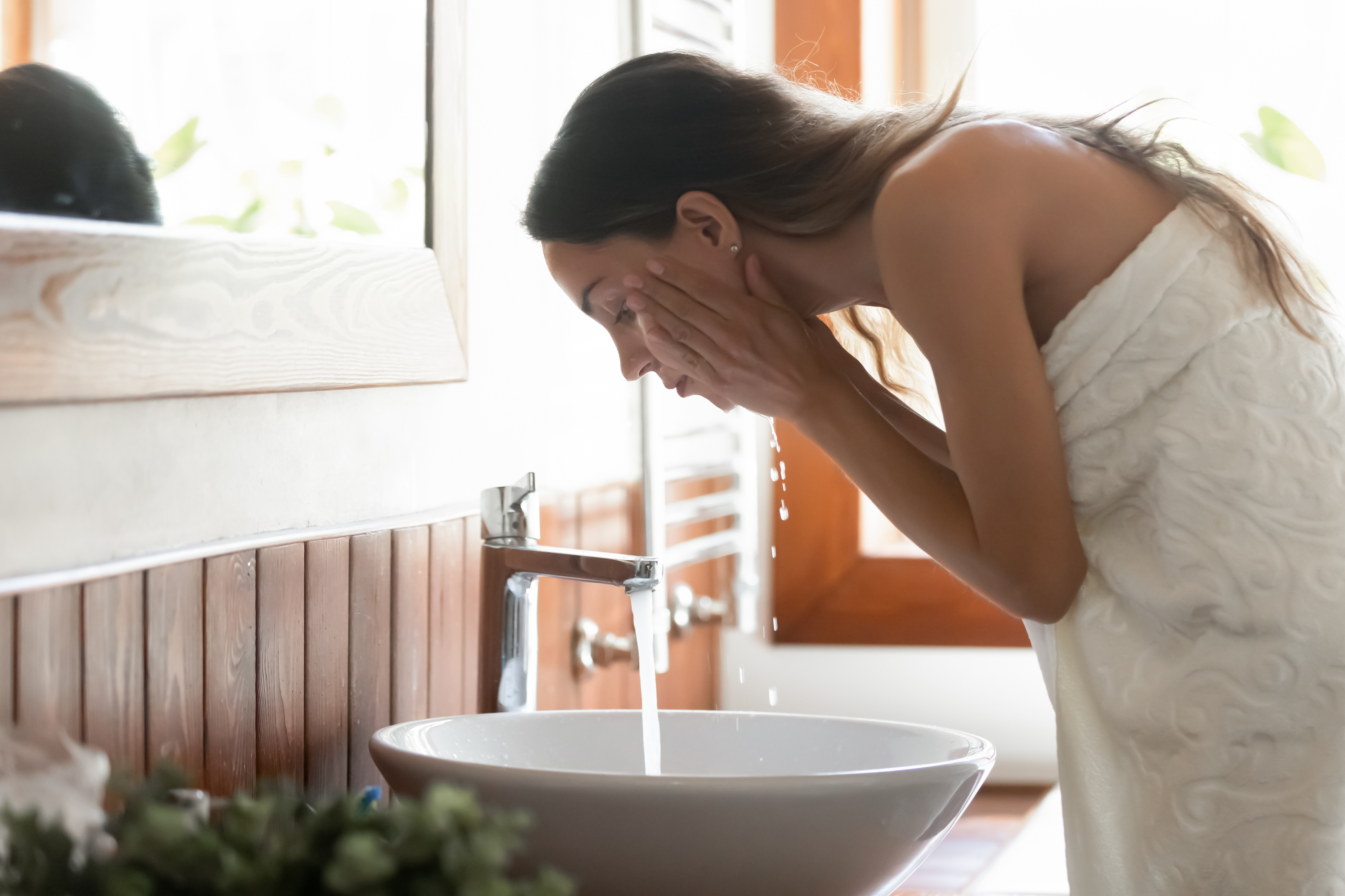 woman cleaning her face