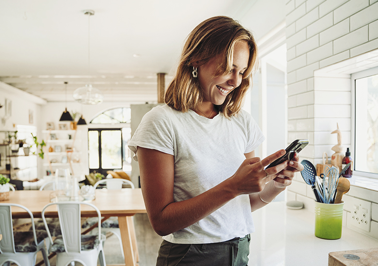 woman with phone kitchen