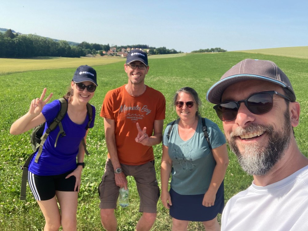 four people smiling at camera