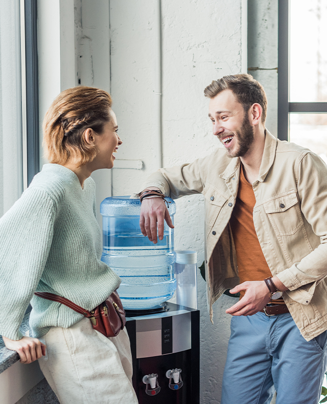 coworkers chatting at the water fountain