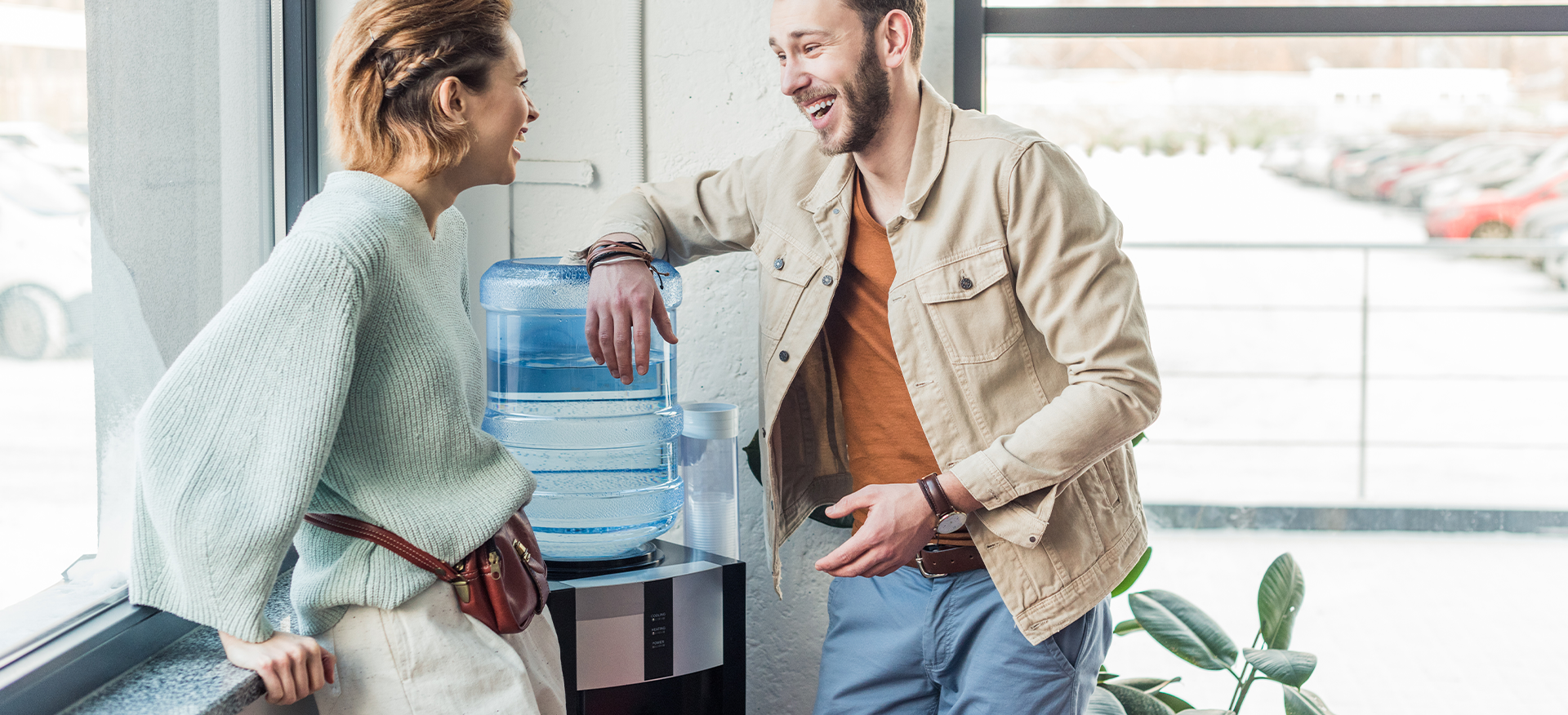 coworkers chatting at the water fountain