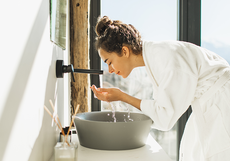 woman washing her face